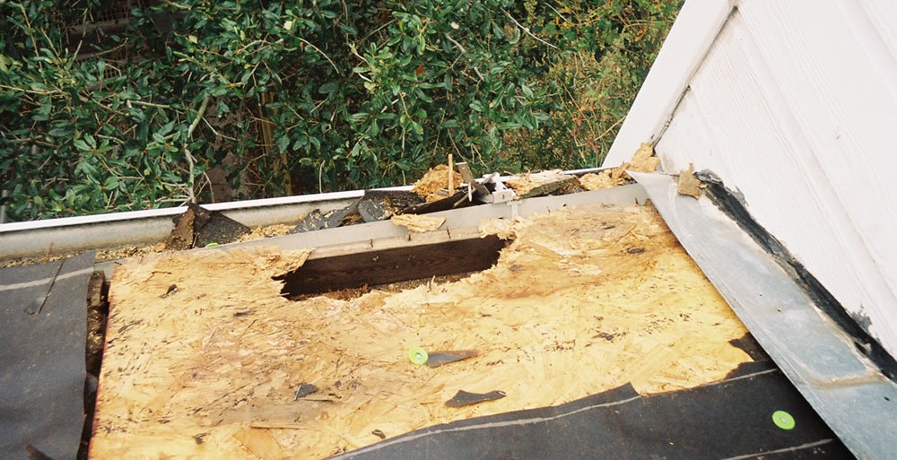 Houston roof repair work on a shingle roof above a residential building