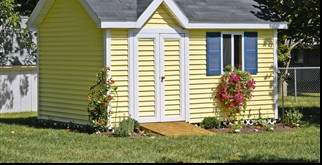 white backyard storage shed with double doors and a gable roof in Houston